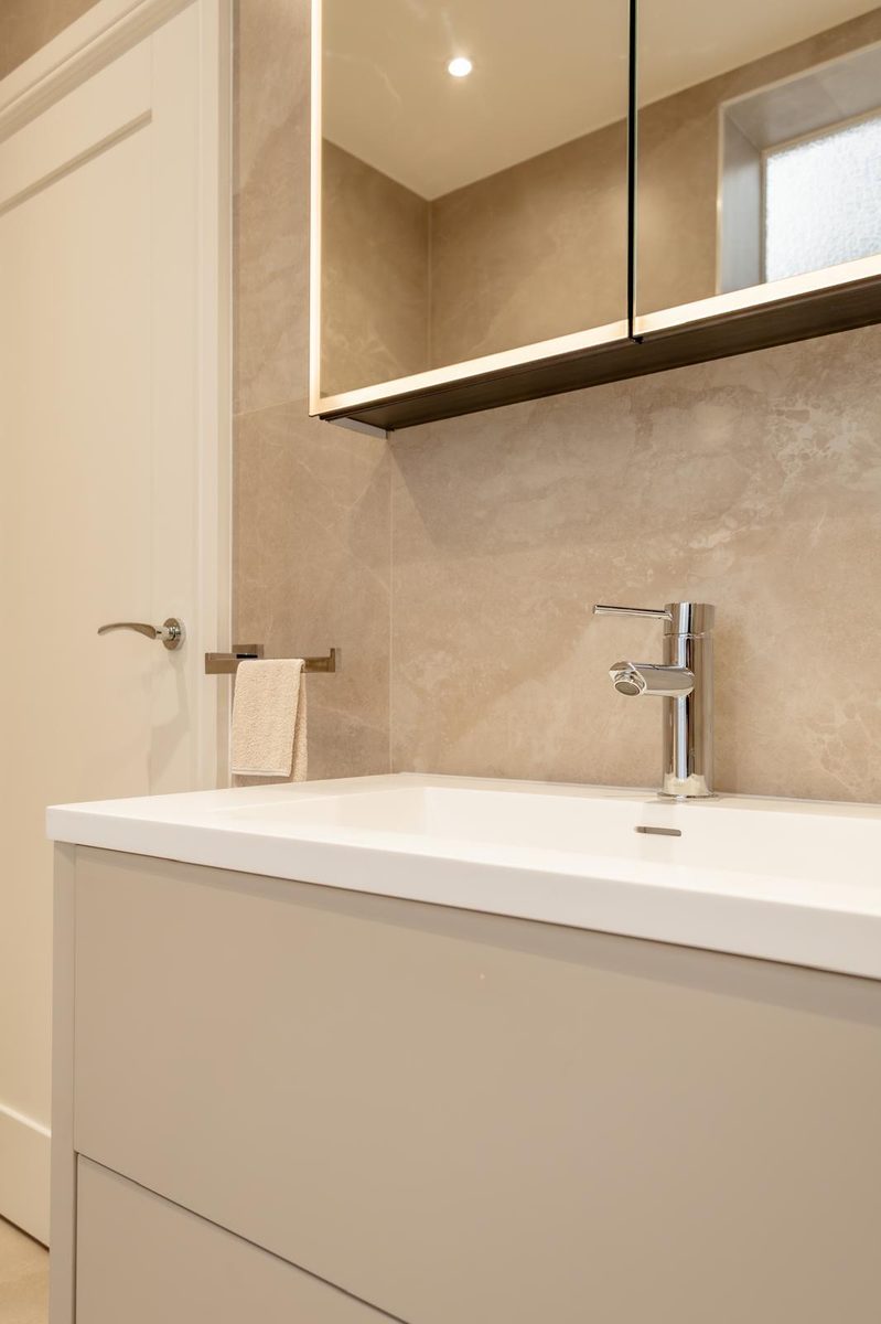 Bathroom vanity with mirror cabinet and chrome tap