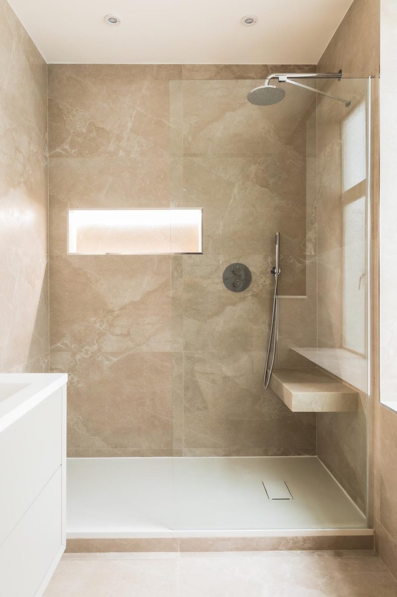 Walk-in shower with rainfall head and glass screen