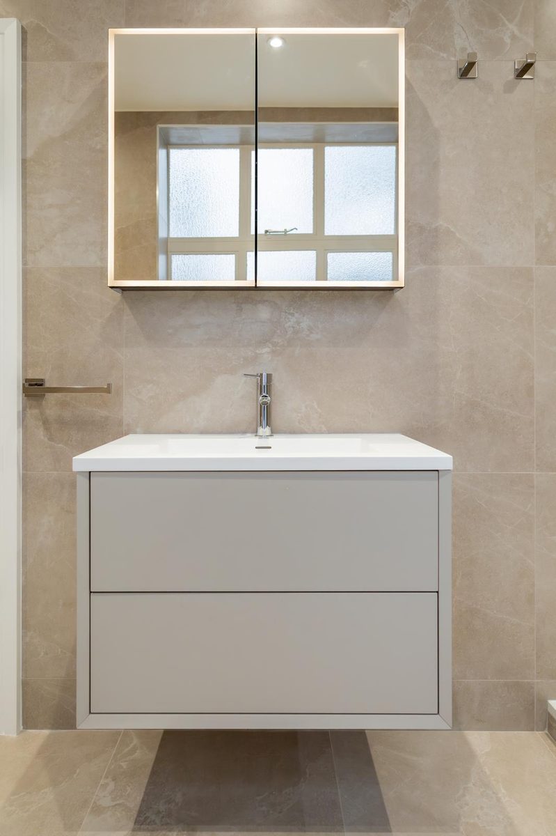 Vanity with mirror cabinet and shower tray