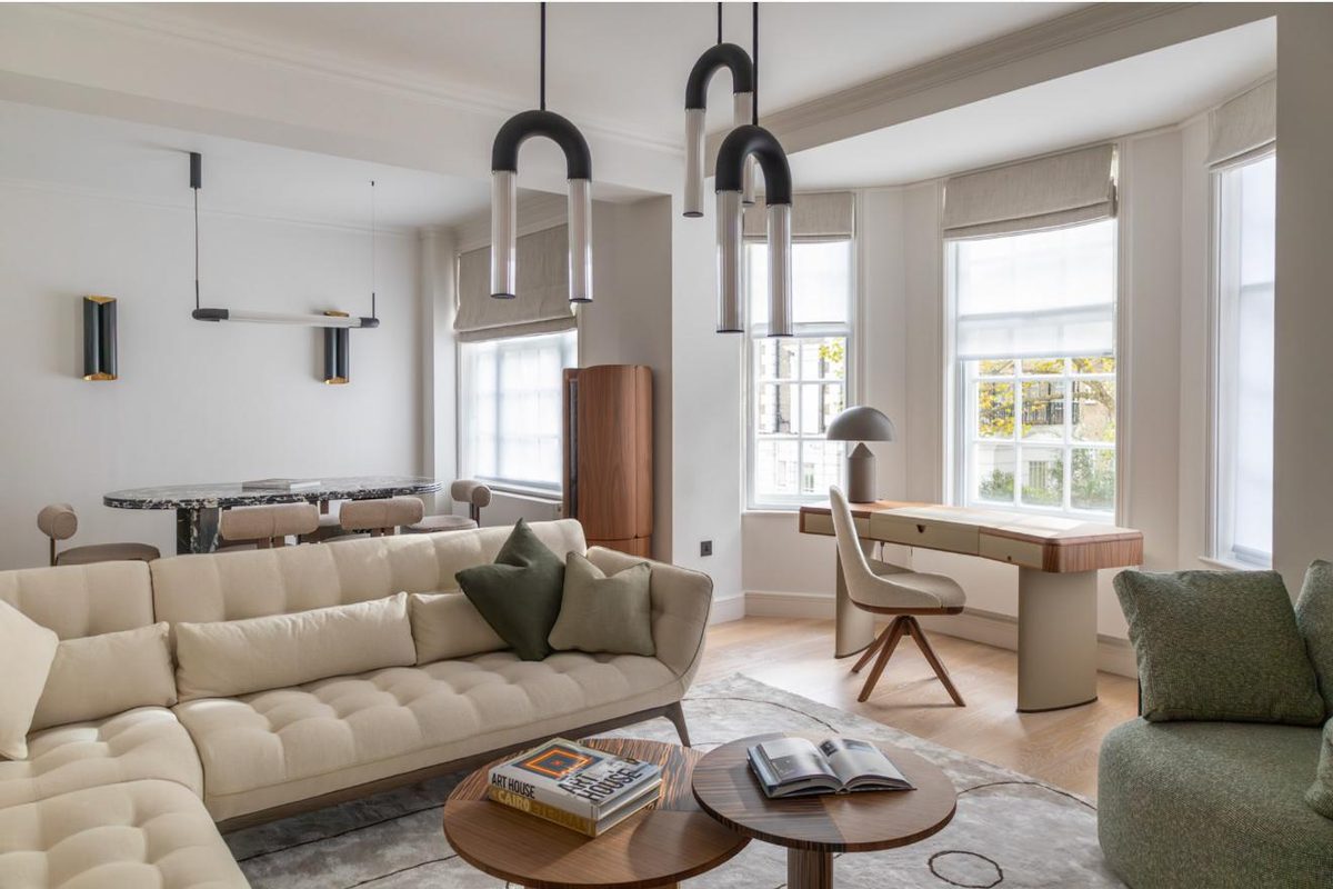 Open-plan living room with sectional sofa and pendant lights